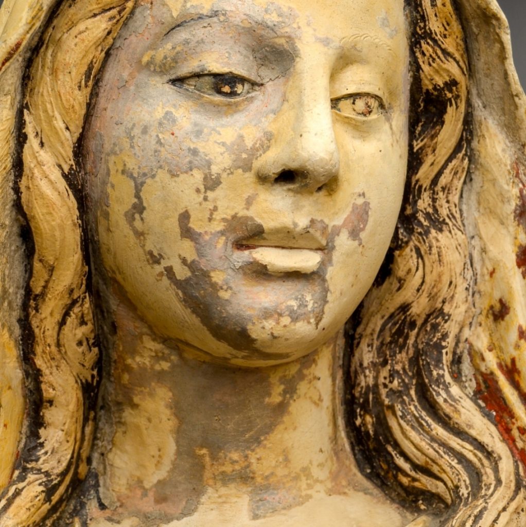 Virgins's face. Detail of the Polychromed limestone sculpture of Saint Mary the Beautiful